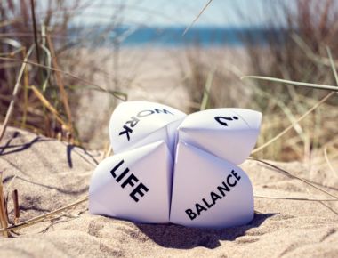 Origami fortune teller on vacation at the beach concept for work life balance choices